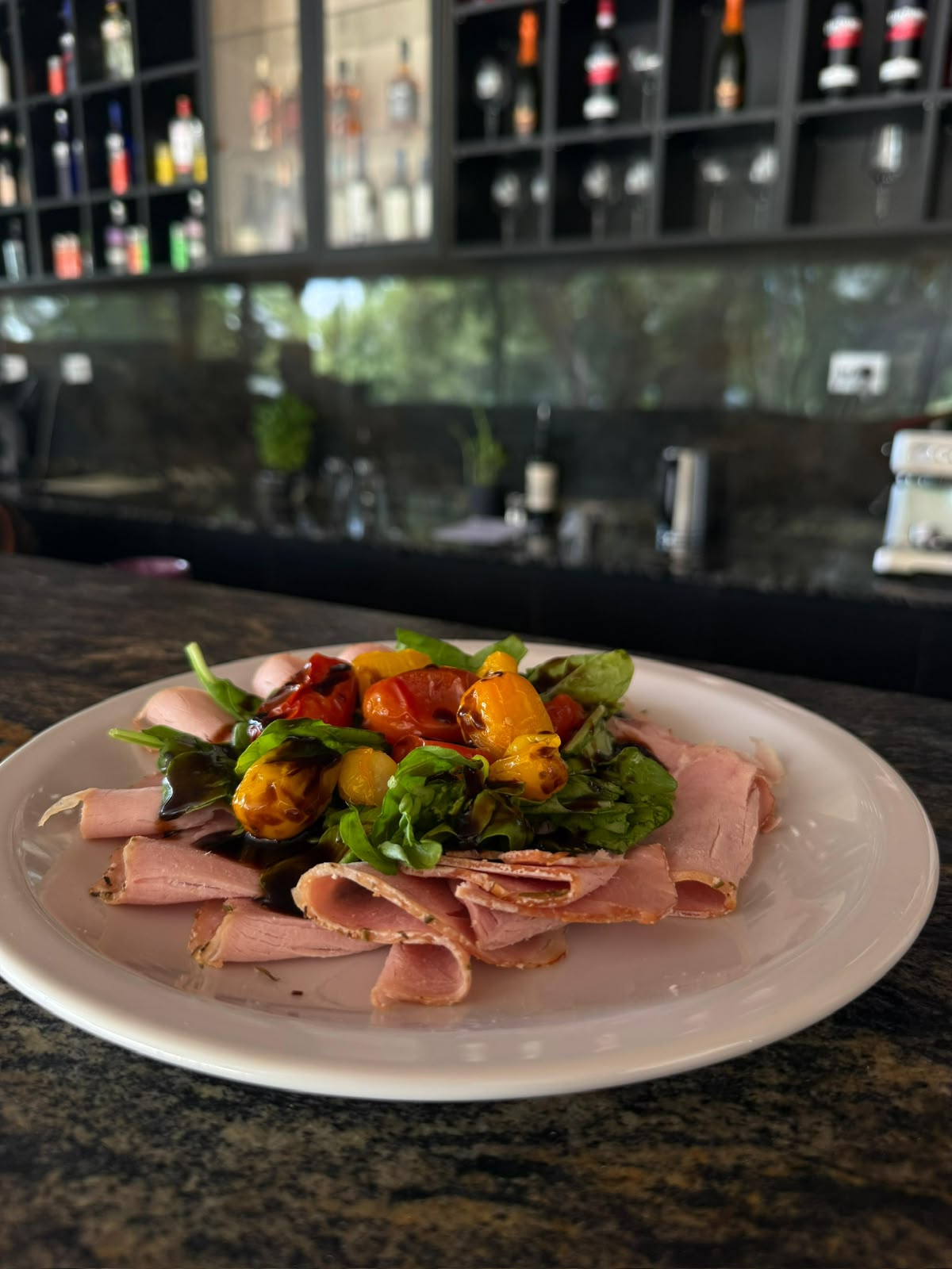 Cured ham platter with arugula, roasted cherry tomatoes and balsamic glaze